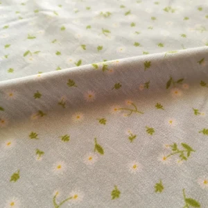 پارچه تریکو طرح گل ریز زمینه آبی روشن