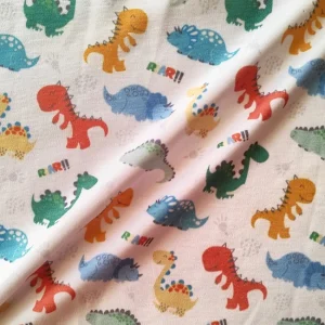 پارچه تریکو پنبه ترکیبی طرح دایناسورهای رنگی