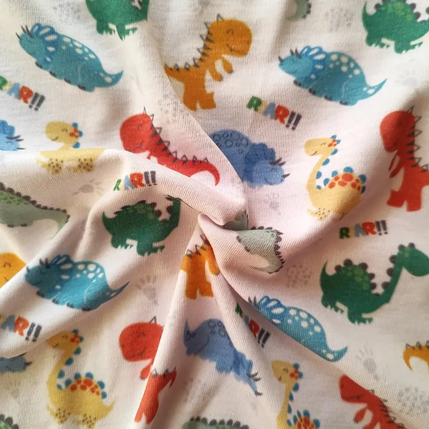 پارچه تریکو پنبه ترکیبی طرح دایناسورهای رنگی