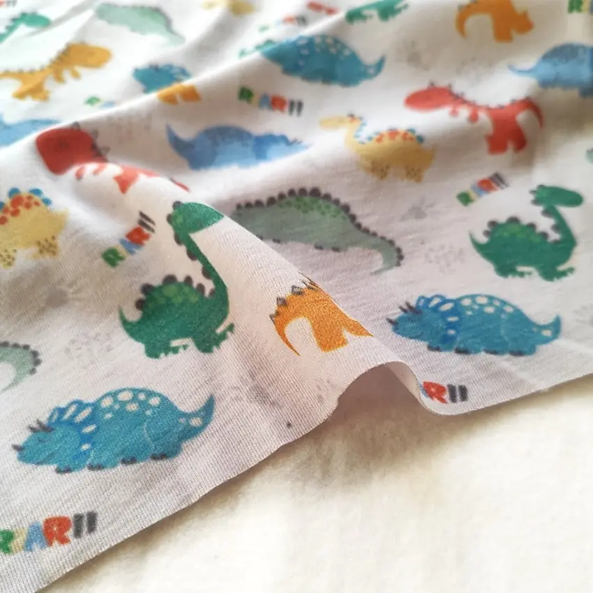 پارچه تریکو پنبه ترکیبی طرح دایناسورهای رنگی